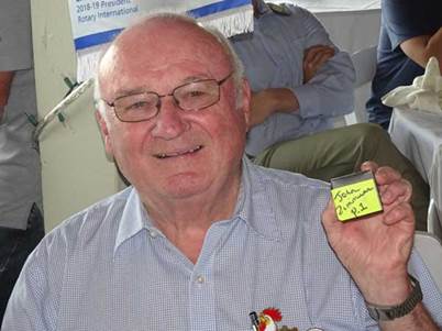 A person holding a small square object with a yellow paper

Description automatically generated