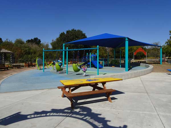 A playground with a blue canopy

Description automatically generated