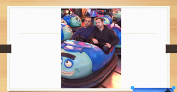 A couple of men in a bumper car

Description automatically generated