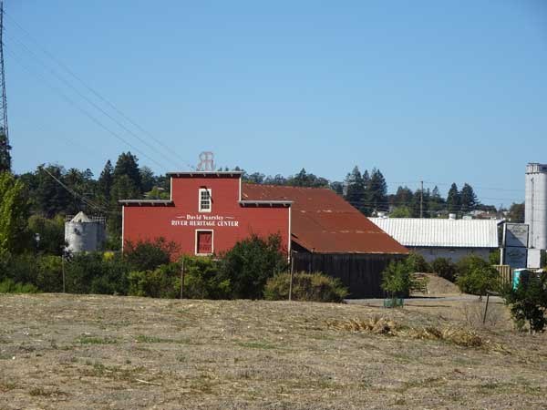 A red building in a field

Description automatically generated