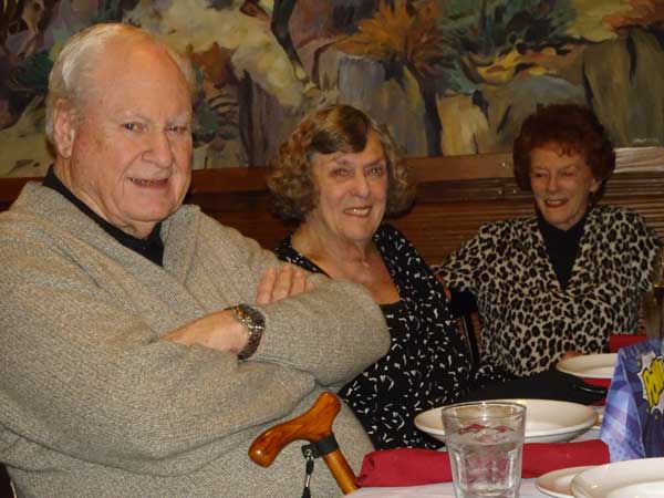 A group of elderly people sitting at a table

Description automatically generated