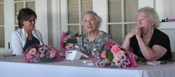 A person sitting at a table with flowers

Description automatically generated