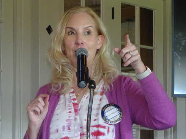 A person with a microphone pointing at something

Description automatically generated