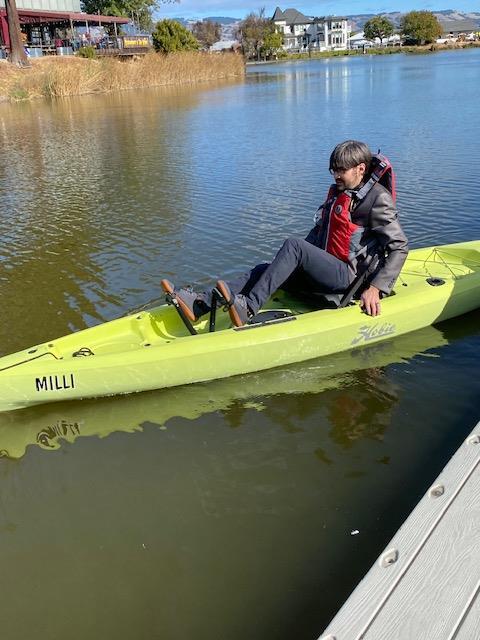 A person in a kayak on a body of water

Description automatically generated