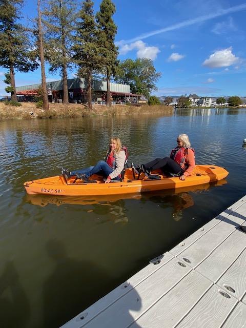 Two women in a kayak on a lake

Description automatically generated